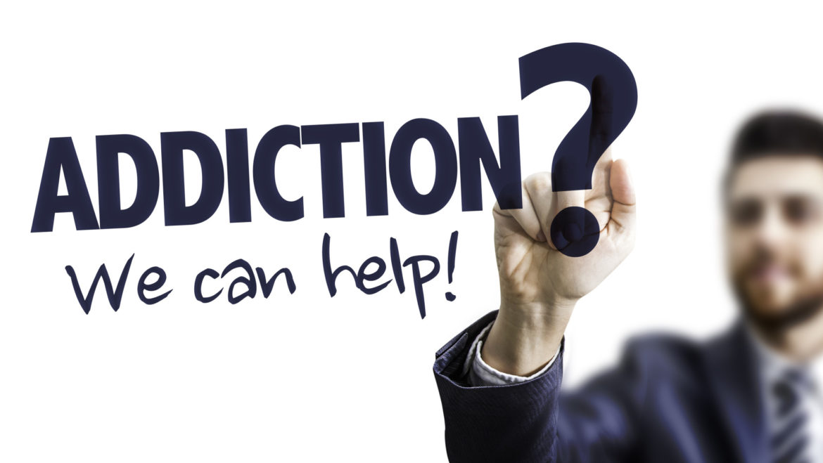Business Man Pointing the Text: Addiction? We Can Help!